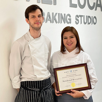 Chef Lucas and a student holding her diploma