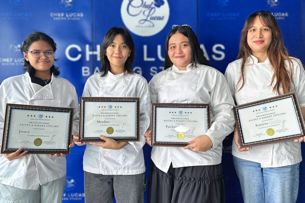Group of students standing together, each proudly holding their certificates after completing the Grand Baking Course.